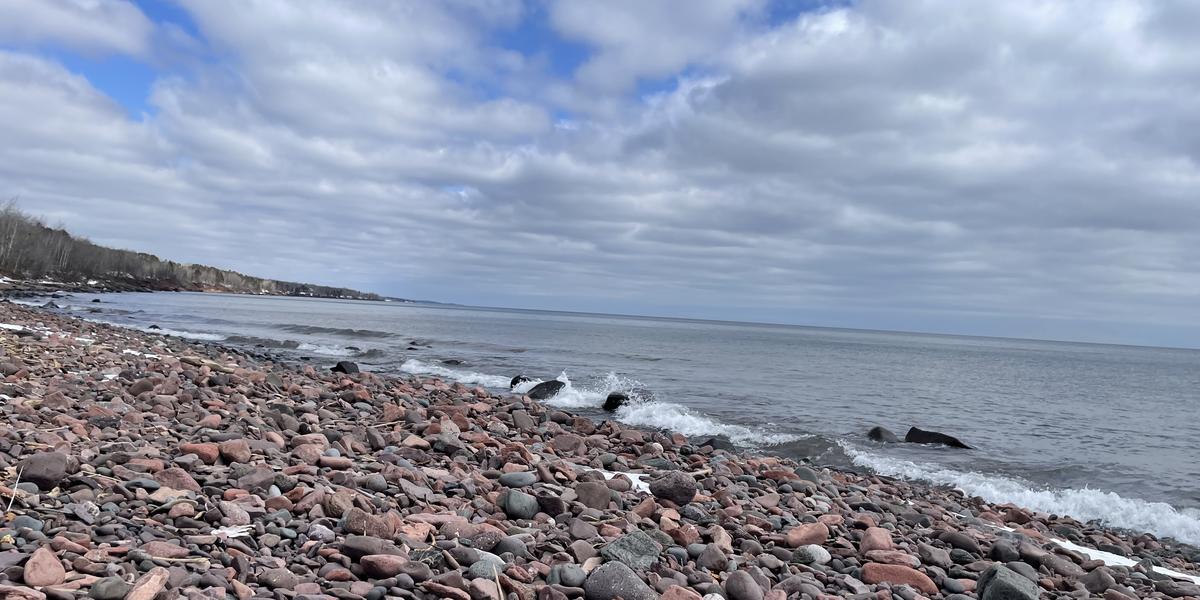 Rocky beach on Lake Superior with clouds and blue sky