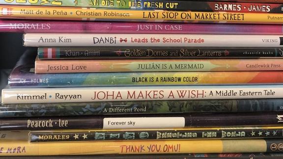 A stack of picture books, with titles about diversity and inclusion.