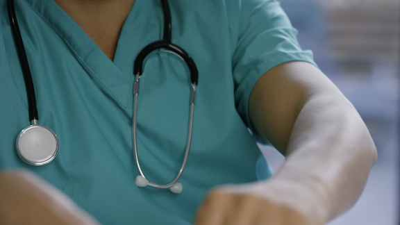 Upclose shot of someone wearing scrubs and a stethoscope