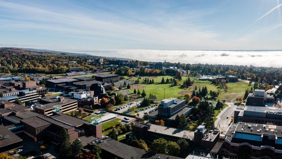 An aerial view of campus with a cloud inversion over Lake Superior