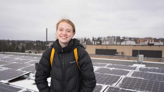 UMD Student Remi Foust in front of the HCAMS solar array on a winter morning.