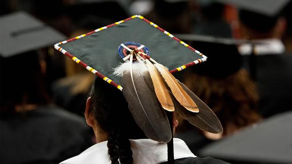 Back of mortar board with a feather and bead work.