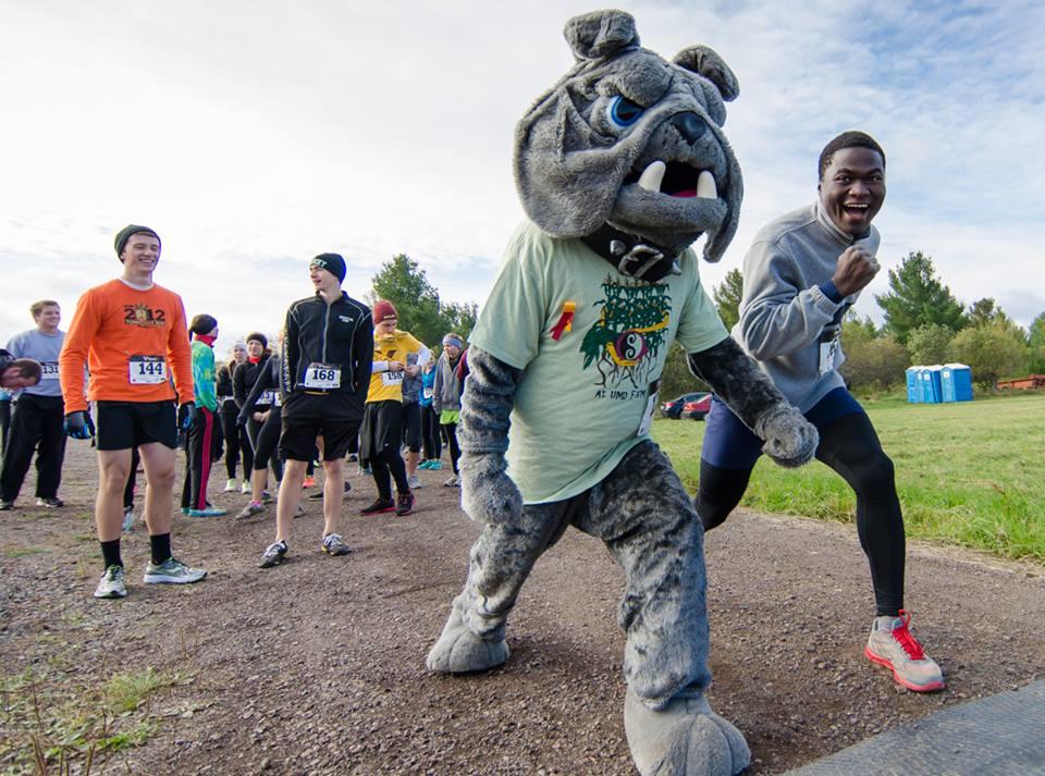 Trail racers at UMD's Food and Farm Festival lineup with Champ