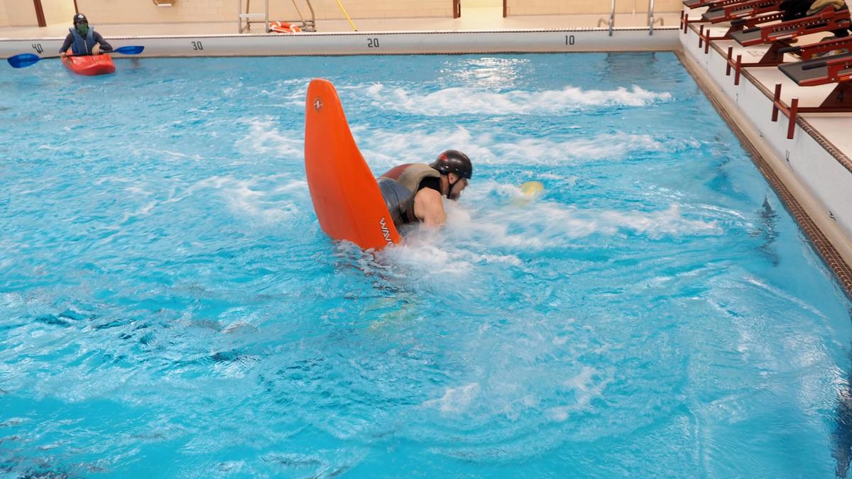 Randy demonstrating kayaking in pool with flow pump
