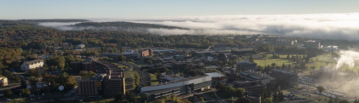 An aerial photo of campus on a foggy morning