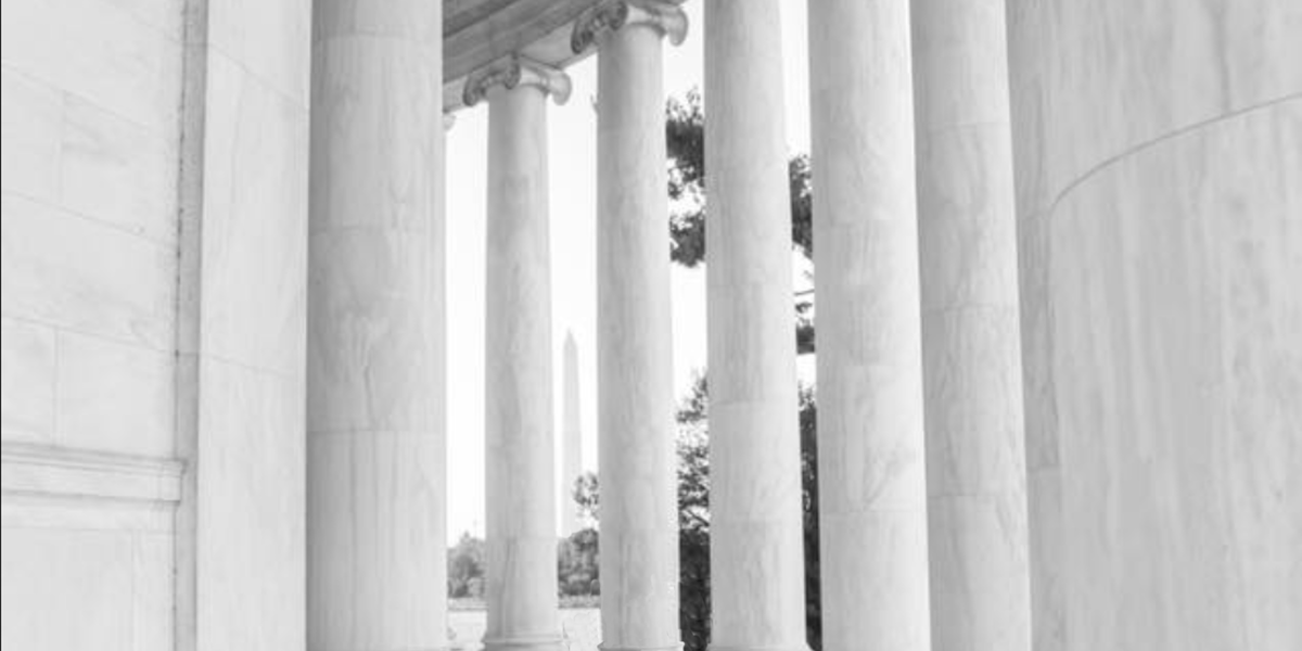 A view of the Washington Monument through pillars