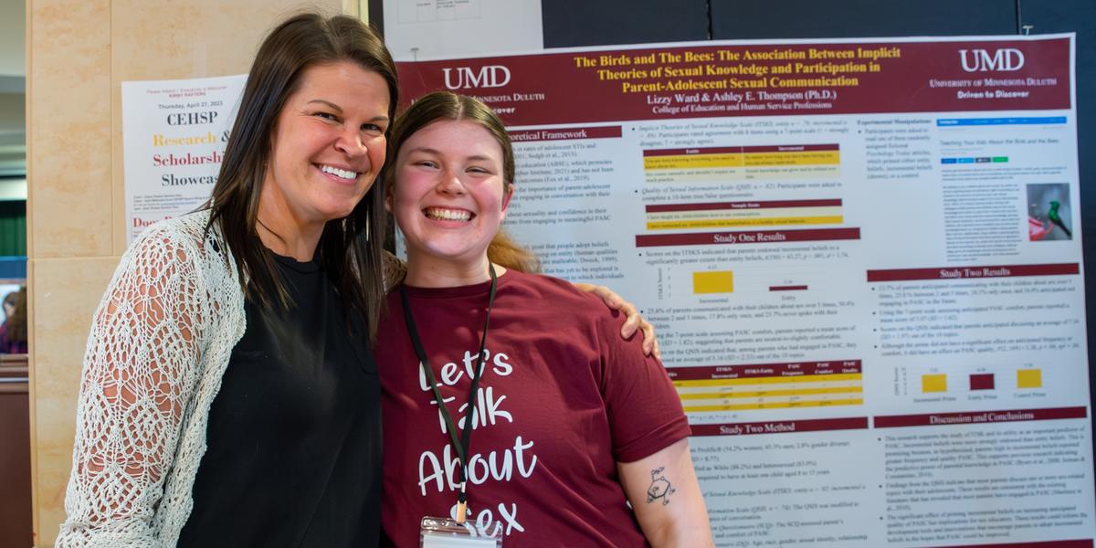 Ashley Thompson and Lizzy benson in front of Lizzy's research poster