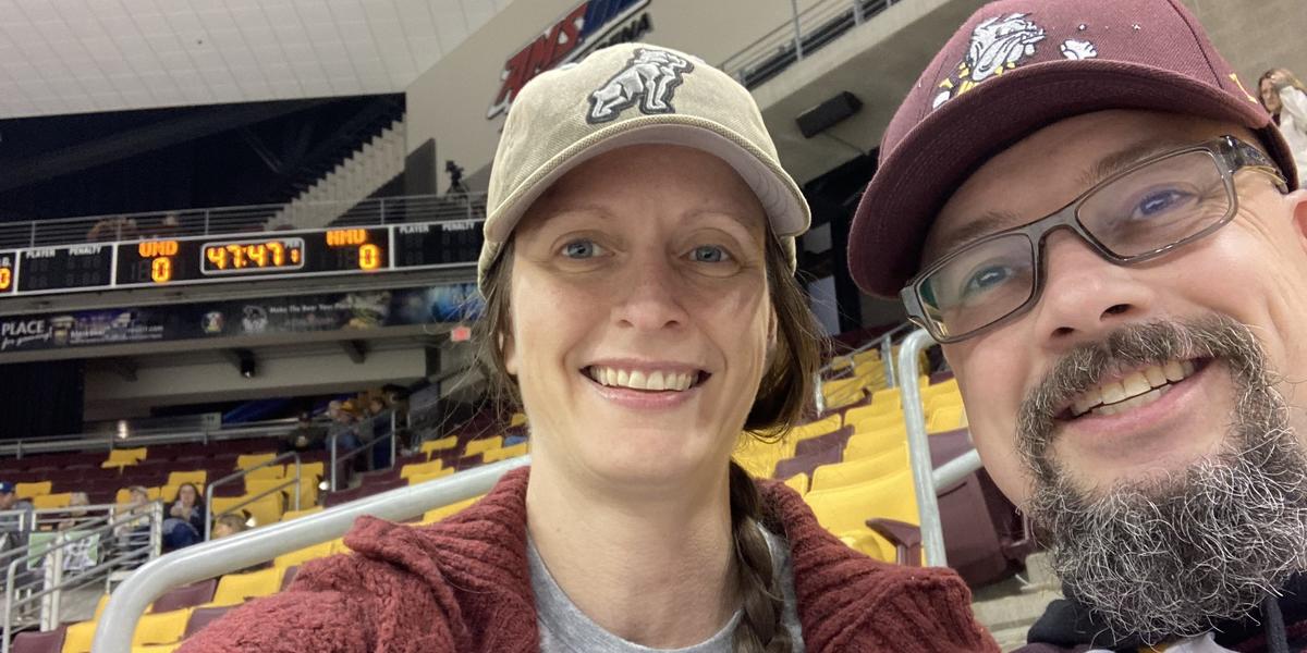 Meredith Schneider and her husband at a bulldog hockey game