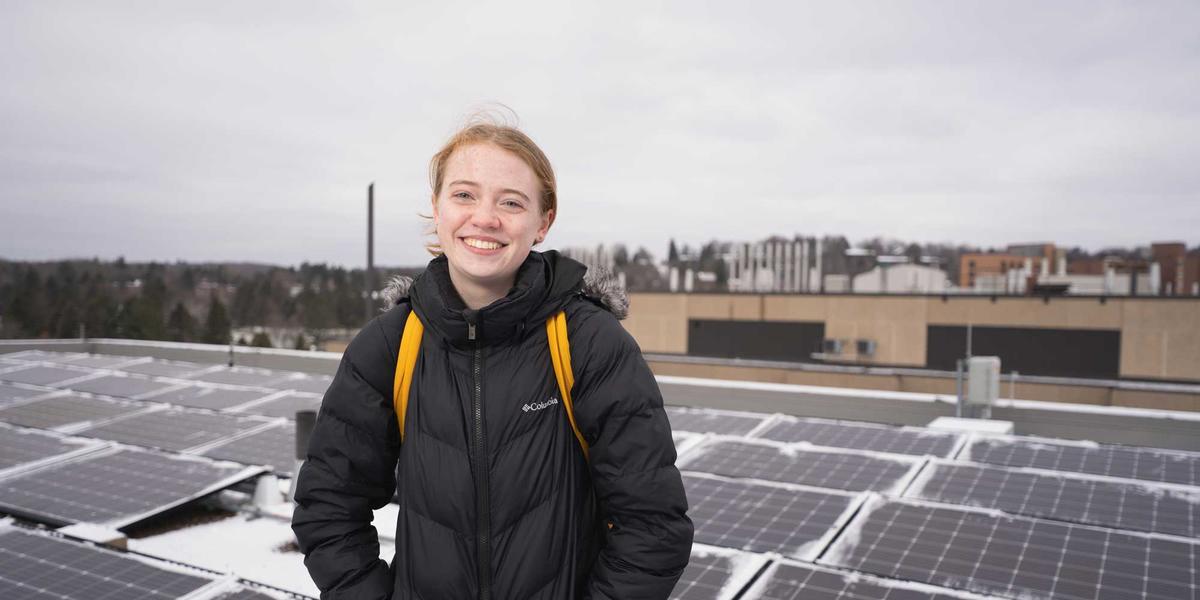 UMD Student Remi Foust in front of the HCAMS solar array on a winter morning.