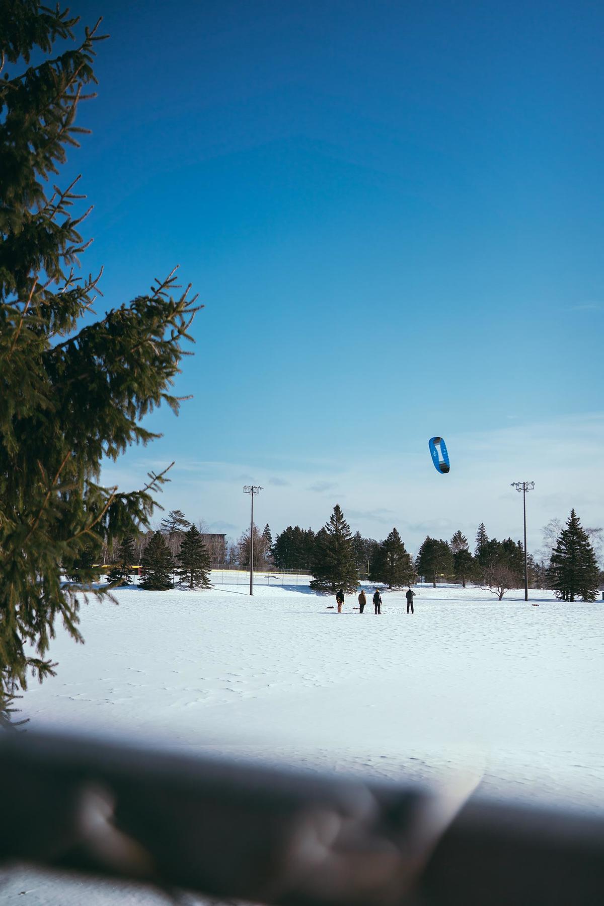 Students work with instructor Randy Carlson to learn snowkiting on the University of Minnesota Duluth campus.