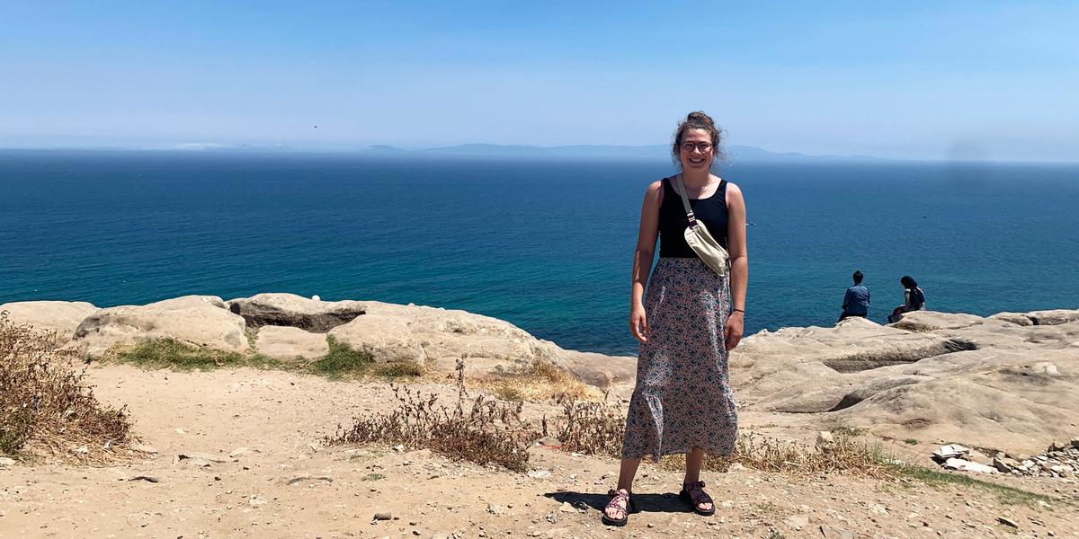 UMD Alum Nora Griffin-Wiesner poses for a photo near the ocean in Morocco during her undergraduate research study abroad trip.