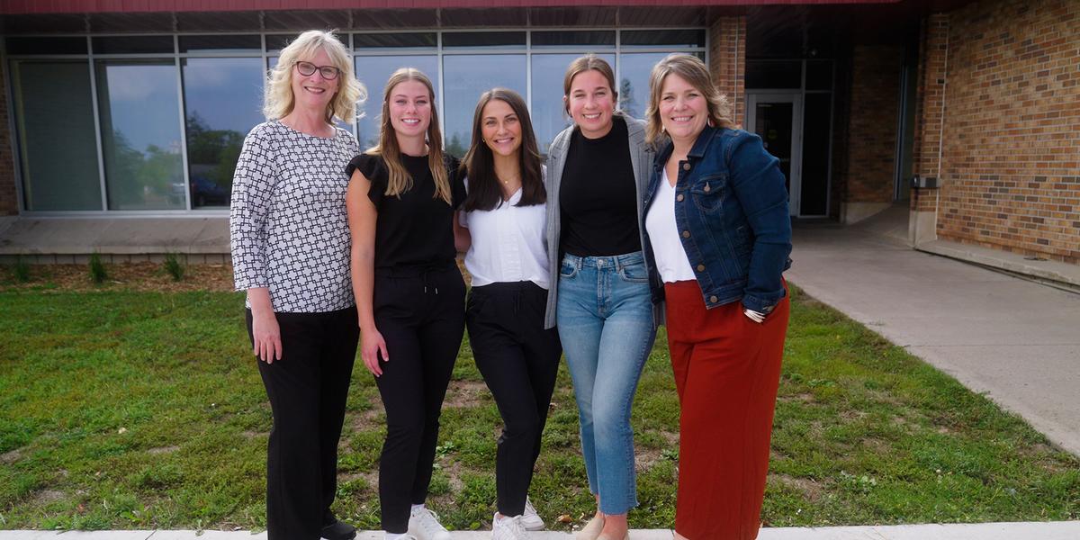 Research team in front of the Chester Park building: Instructor Lynette Carlson, Haley Evans, Madelyn Graham, Marie Meysembourg and Associate Professor Sharyl Samargia-Grivette.
