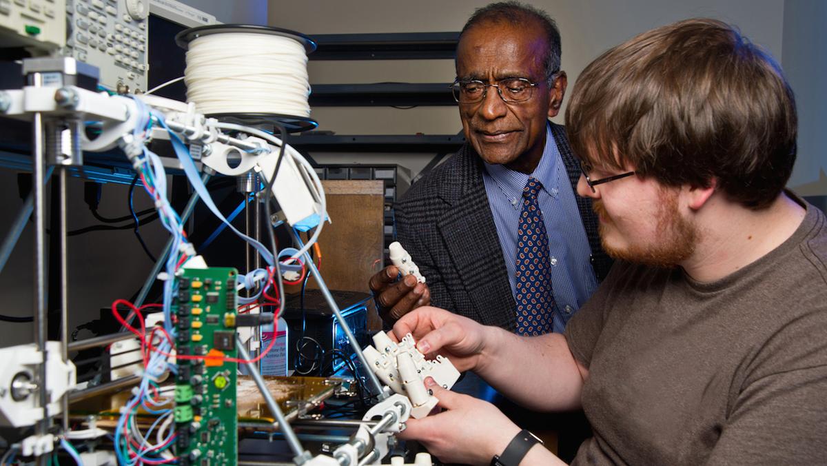 Dr Naidu and student Alex Carter work on the prosthetic hand