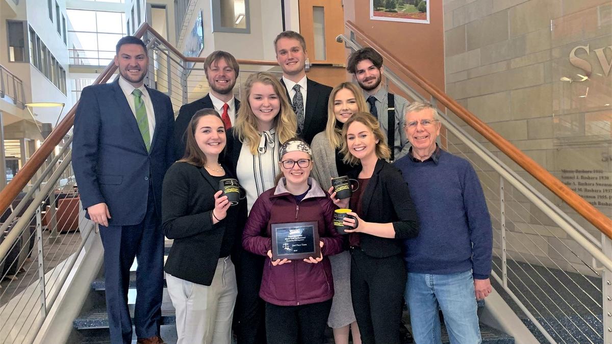 UMD Mock Trial Competition team holding awards they received