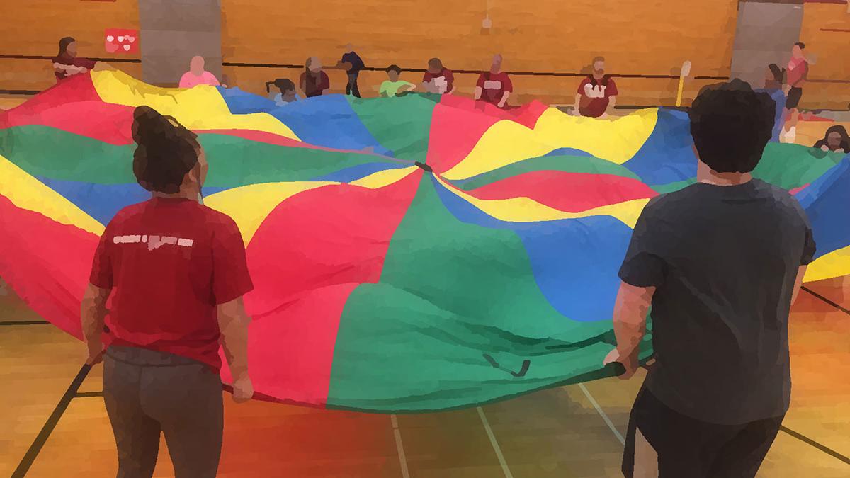 Adapted PE image - children holding the edges of a colorful parachute