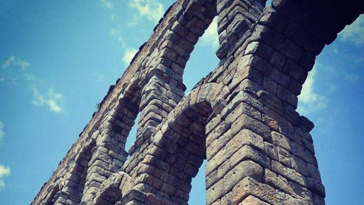 a close-up of the Aqueduct of Segovia stone arches