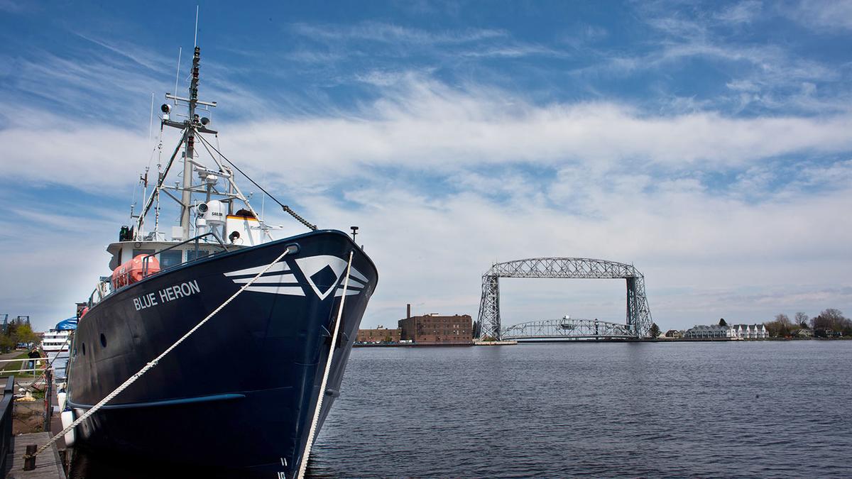UMD's research vessel, the Blue Heron, docked with Aerial Lift Bridge in the background