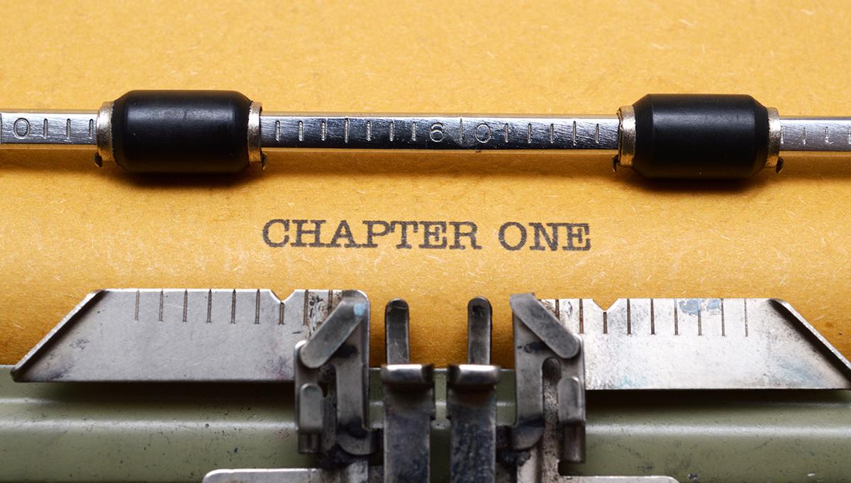 Typewriter and paper with the words "Chapter One"