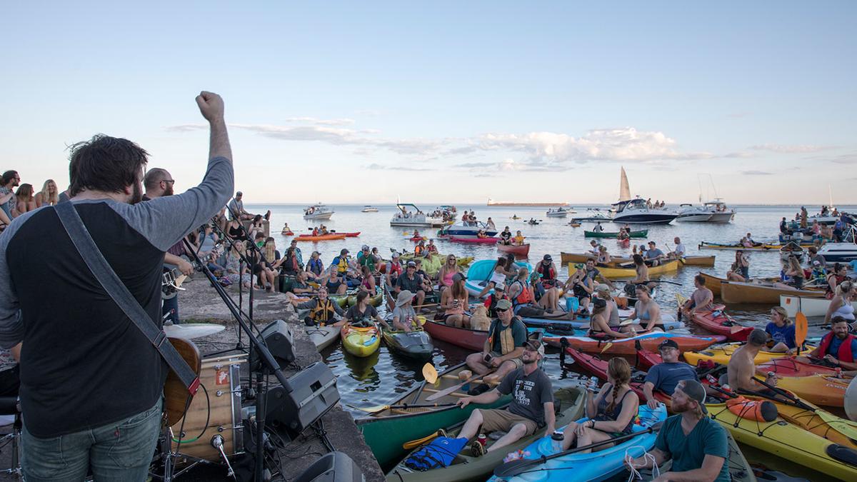 The 4onthefloor performing at Concerts on the Pier in 2017 with lots of people watching from kayaks