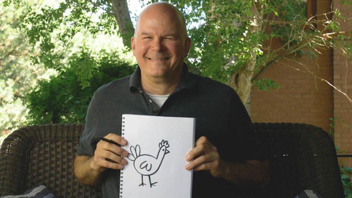 Mike Scholtz hold a black & white drawing of chicken