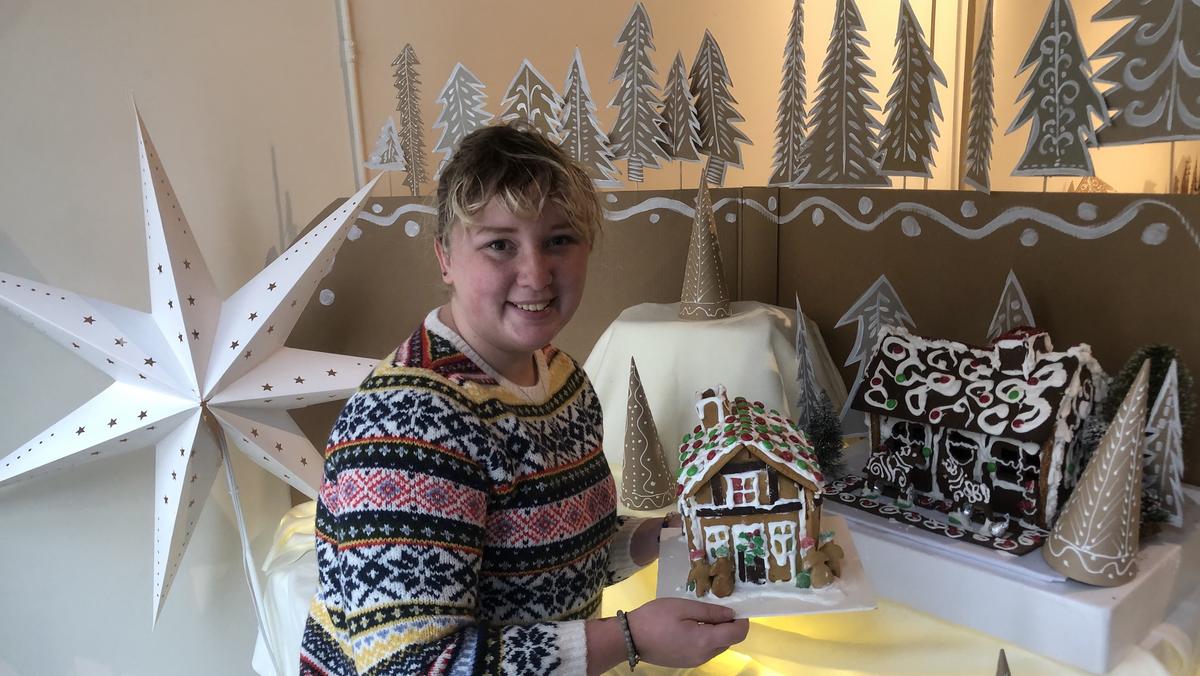Anabelle Putz sets up the gingerbread village.