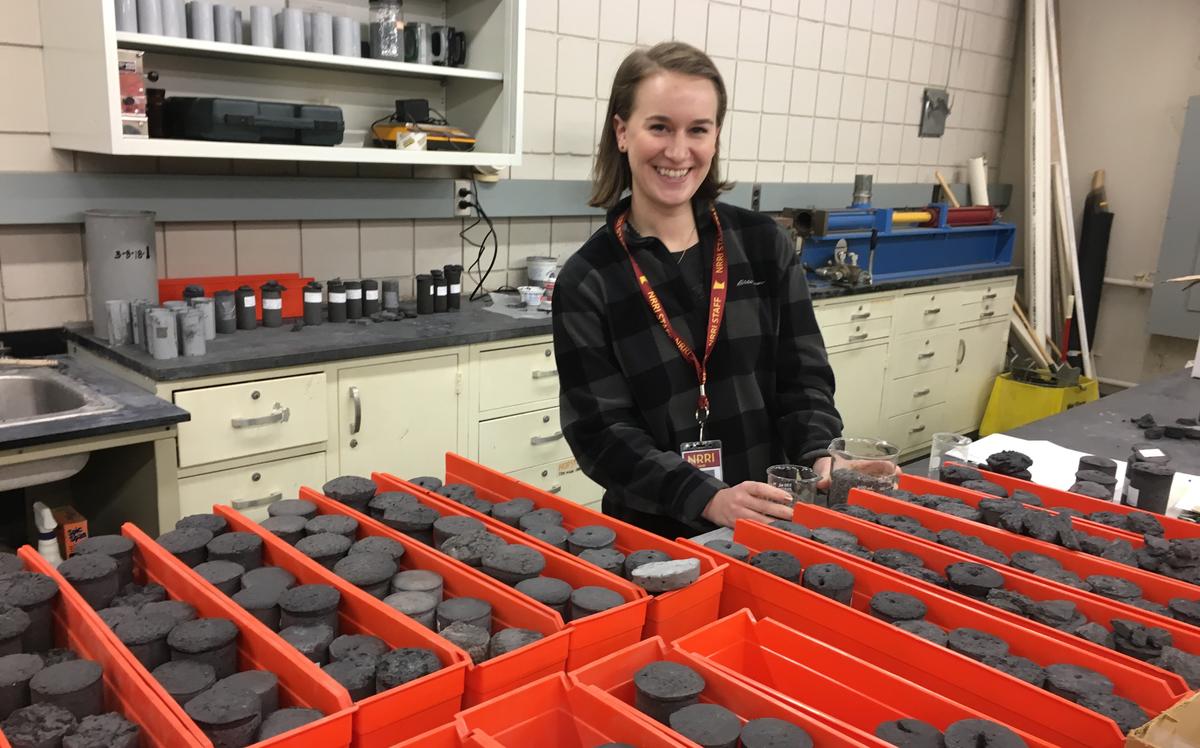 UMD student Jackie Drazan in a lab with rocks on a table