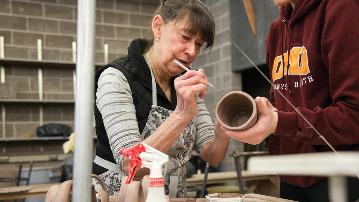 UMD School of Fine Arts Assistant Professor Elizabeth James working on a clay pot