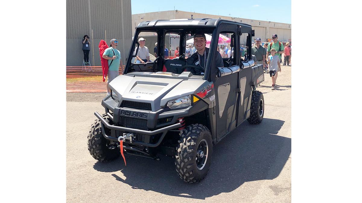 UMD student Jon Emhke behind the wheel of a Polaris Ranger at the Duluth Airshow
