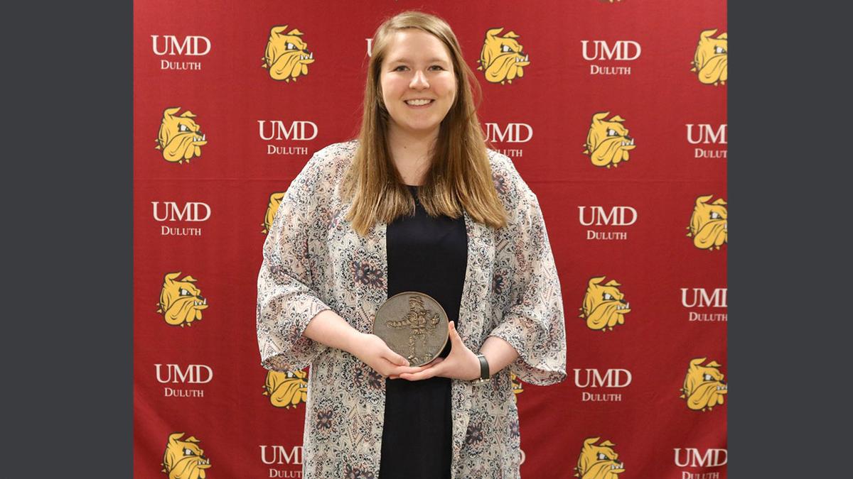 UMD Student Lindsey Dirks holding Sieur du Luth Award