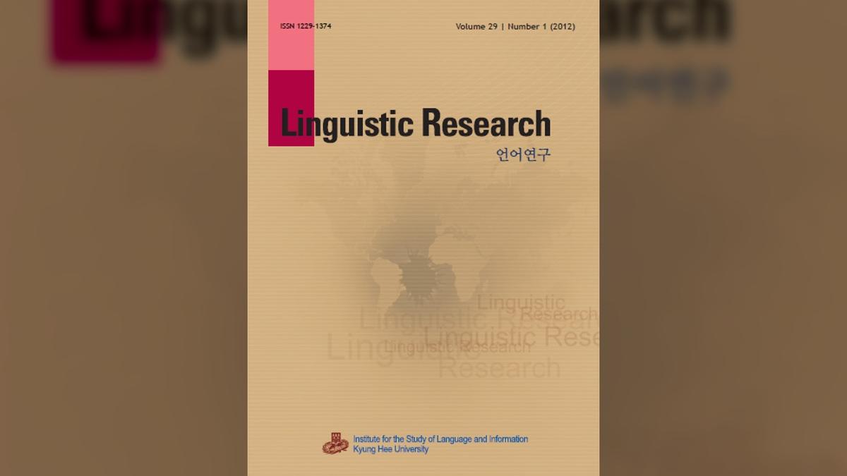 Piece of paper with the words "Linguistic Research" and blurry world map on it. 