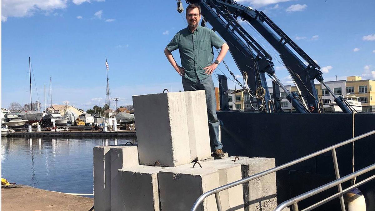 UMD LLO researcher Jay Austin with 1000 pound concrete weights