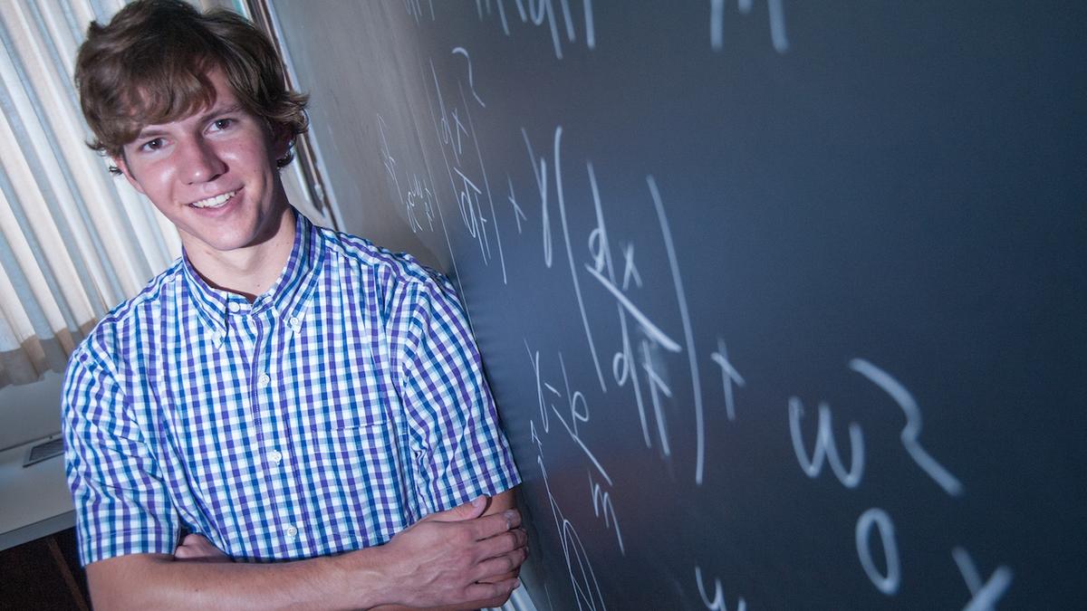 Mark Kallevig and a blackboard covered in formulas