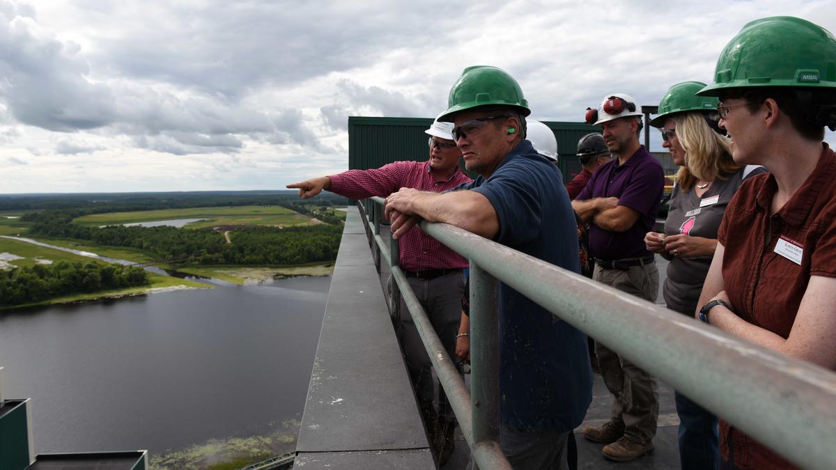 A group of SCSE professors standing on an Iron Range observation deck. 