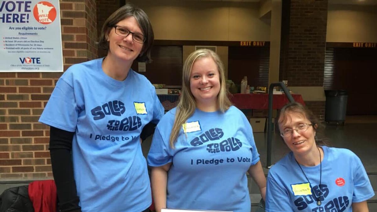 UMD faculty member Sandra van den Bosse with two other people in matching blue t-shirts