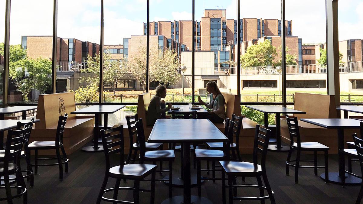 Students enjoying a meal by the spacious windows of UMD's new Superior Dining
