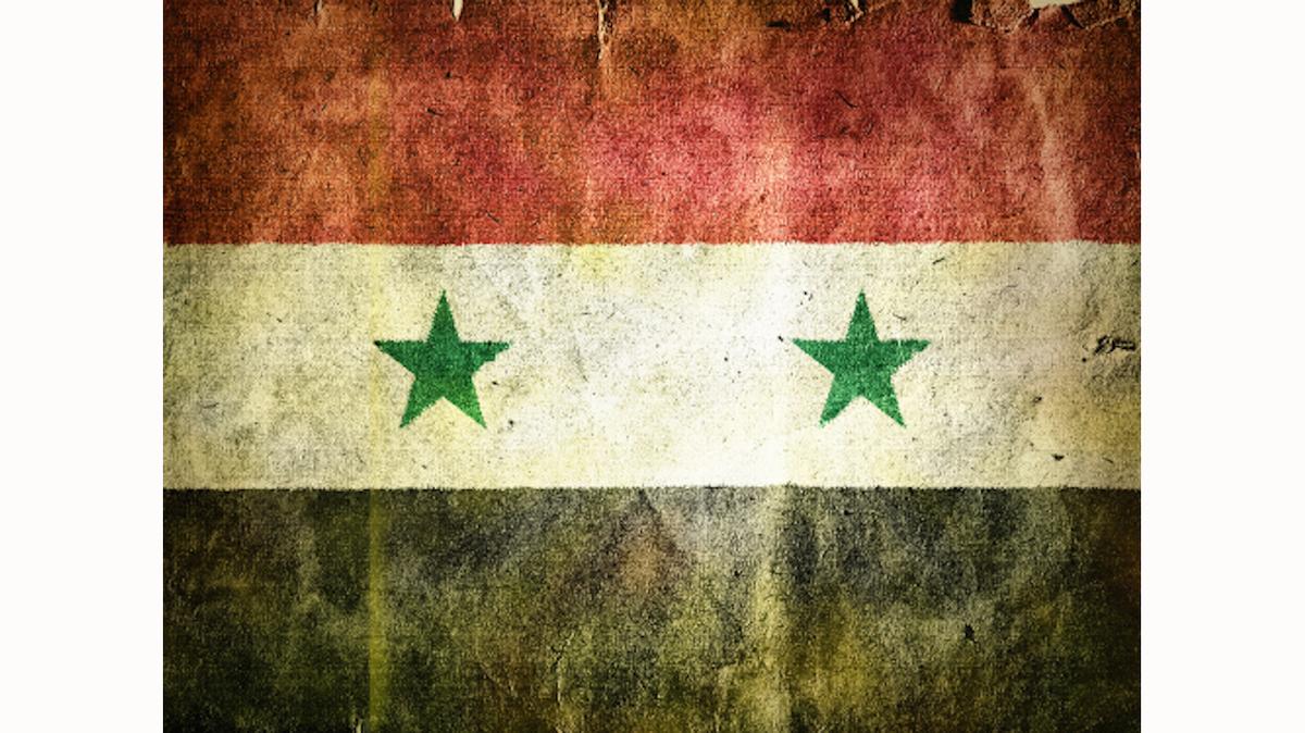 a battered-looking Syrian flag