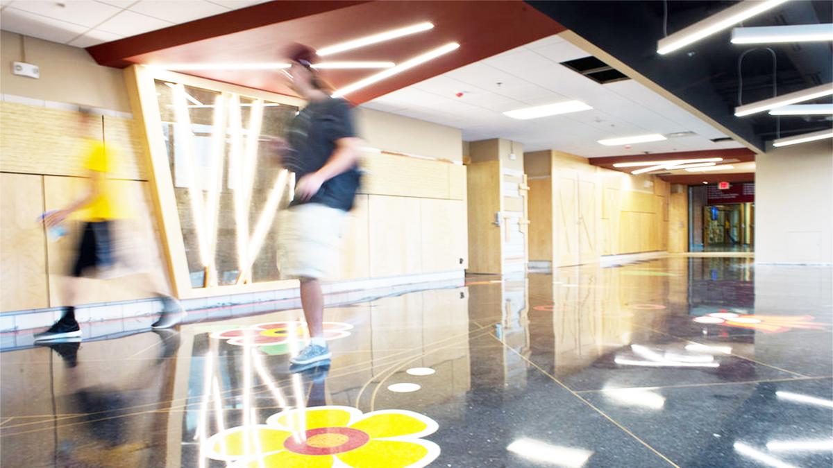 Photo of Cina Hall, focused on flower decal in the floor