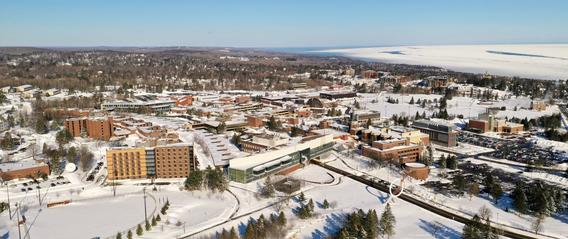 A snowy aerial view of campus and Lake Superior