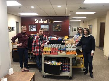 LSBE staff Monica Haynes, Georgina Spears, Cindy Beaudin, and Gina Grensing with the four carts of food donated to Champs Cupboard.