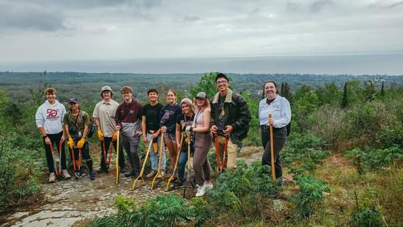 Participants take a break at a trail-clearing event in Duluth. Credit: University of Minnesota Duluth