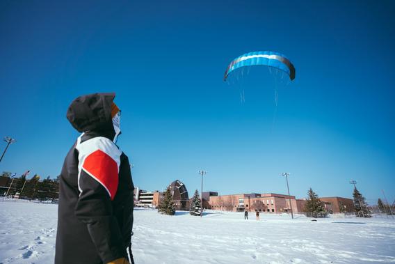Students work with instructor Randy Carlson to learn snowkiting on the University of Minnesota Duluth campus.