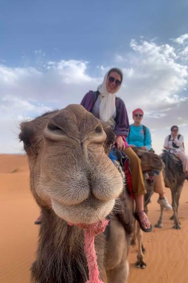 UMD Alum Nora Griffin-Wiesner rides a camel in Morocco while studying abroad.