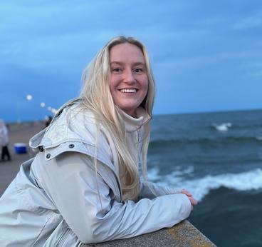 Clara olson smiling on a pier