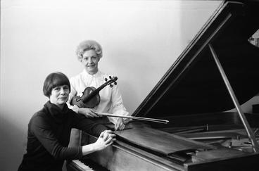 Pat LaLiberte, at the piano, and Ann, with the violin, traveled to area schools to give a concert and encourage students to come to UMD.