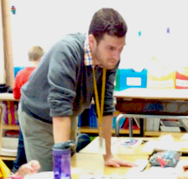 Jackson Pray works with students in his classroom.
