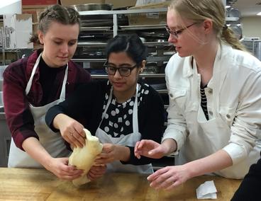 Katie Haus and classmates knead dough. 