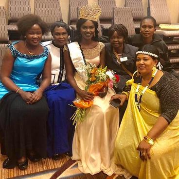 Family members gather around Awel after she was named Miss South Sudan 2018.