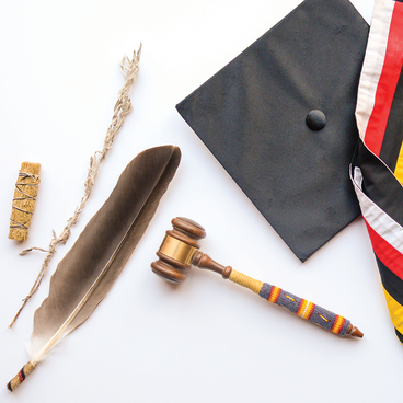 An image showing artifacts from UMD's history. Sage, a feather, a gavel, and graduation cap and stole.