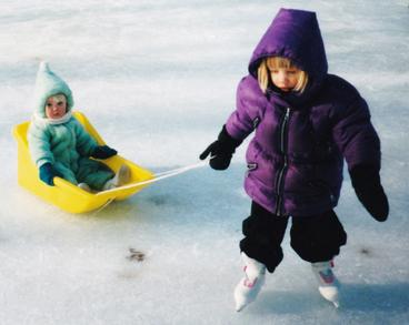 Hockey players and sisters as kids in Red Wing, Minn. Paige pulls sister Reagan Haley in the ice.