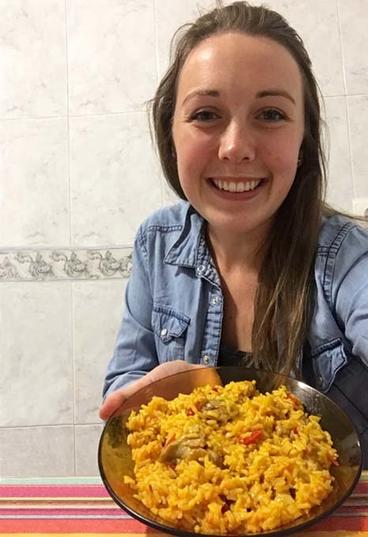 Abby with a plate of paella made by her host mother.